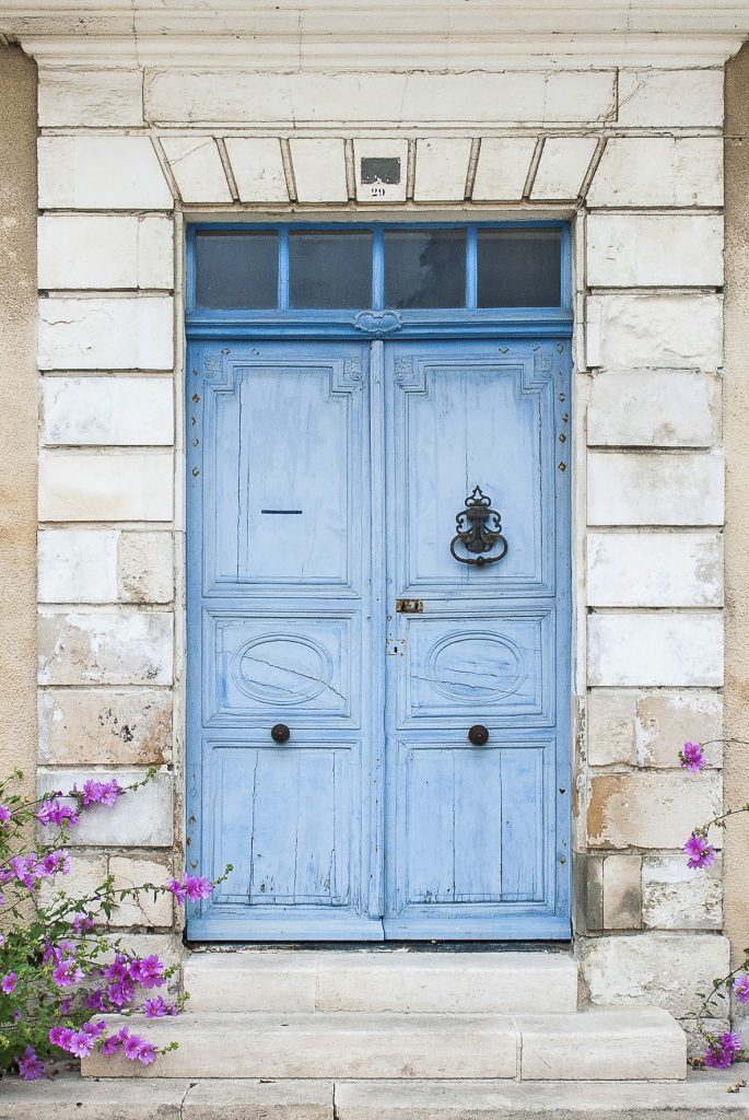 Doors in France on the Île de Ré showing elegant pale blue painted double doors with classical proportions